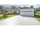 Charming single-story home with a well-manicured lawn, mature landscaping, and a two-car garage at 2908 Cypress Ridge Trl, Port Orange, FL 32128