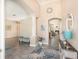Grand foyer featuring tile floors, columns, and an archway leading to the living spaces at 2908 Cypress Ridge Trl, Port Orange, FL 32128