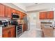 Functional kitchen boasting wooden cabinetry, modern appliances, and tile floors for easy maintenance at 2908 Cypress Ridge Trl, Port Orange, FL 32128