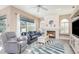 Bright living room showcasing a fireplace, large windows, and tile flooring, creating a cozy ambiance at 2908 Cypress Ridge Trl, Port Orange, FL 32128