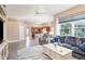 Open-concept living room featuring a large window, tile flooring, and seamless access to the kitchen area at 2908 Cypress Ridge Trl, Port Orange, FL 32128