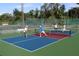 Active community pickleball court with players enjoying a game in a well-maintained area at 2908 Cypress Ridge Trl, Port Orange, FL 32128