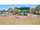Community playground with swings, a slide, and climbing structure offering shaded outdoor fun at 2908 Cypress Ridge Trl, Port Orange, FL 32128