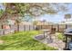 Backyard oasis with table, grill, wooden fence, and lush green grass at 301 N Cooper St, New Smyrna Beach, FL 32169