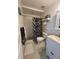 Cozy bathroom featuring a walk-in shower and stylish black and white shower curtain at 301 N Cooper St, New Smyrna Beach, FL 32169