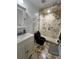 Modern bathroom features a glass-enclosed shower with marbled tile and a stylish black toilet at 301 N Cooper St, New Smyrna Beach, FL 32169