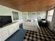 Bright bedroom featuring a white bed, natural light, and a wood plank ceiling at 301 N Cooper St, New Smyrna Beach, FL 32169