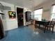 Inviting dining area with tile floors, a vintage cabinet, and beachy decor at 301 N Cooper St, New Smyrna Beach, FL 32169