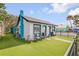 Exterior side view featuring black-framed windows and a turquoise chimney at 301 N Cooper St, New Smyrna Beach, FL 32169