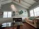 Inviting living room featuring vaulted ceilings, large windows, and stylish decor at 301 N Cooper St, New Smyrna Beach, FL 32169