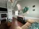 Cozy living room featuring a fireplace, vaulted ceilings, and comfortable seating at 301 N Cooper St, New Smyrna Beach, FL 32169
