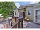 A deck with a table and chairs in a backyard with some trees at 303 Washington St, New Smyrna Beach, FL 32168