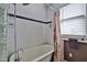 Bathroom features a bathtub with shower and glass block window to let the sunshine in at 303 Washington St, New Smyrna Beach, FL 32168
