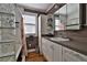 Classic bathroom boasts a shower/tub with white vanity, hardwood floors, and ample cabinet space at 303 Washington St, New Smyrna Beach, FL 32168
