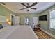 Relaxing bedroom featuring ceiling fan, hardwood floors, and great natural light at 303 Washington St, New Smyrna Beach, FL 32168