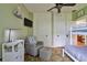Comfortable bedroom featuring built-in storage, a cozy armchair, and a gray color scheme at 303 Washington St, New Smyrna Beach, FL 32168