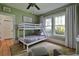 Bright bedroom with bunk beds, neutral decor, and large windows, ideal for a room at 303 Washington St, New Smyrna Beach, FL 32168