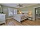 Bright bedroom with hardwood floors, ceiling fan, and plenty of natural light at 303 Washington St, New Smyrna Beach, FL 32168
