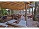 Spacious outdoor deck with seating, a dining area, and a partially covered structure at 303 Washington St, New Smyrna Beach, FL 32168