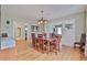 Bright dining room featuring light hardwood floors and seamless access to the living room, enhancing the open feel at 303 Washington St, New Smyrna Beach, FL 32168