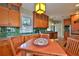 Bright kitchen with wood cabinets, green tiled backsplash, stainless steel appliances and breakfast nook at 303 Washington St, New Smyrna Beach, FL 32168
