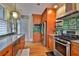 Bright kitchen featuring stainless steel appliances, custom cabinets, and hardwood floors at 303 Washington St, New Smyrna Beach, FL 32168