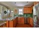 Kitchen with stainless appliances, dark wood cabinets, and beautiful green backsplash at 303 Washington St, New Smyrna Beach, FL 32168