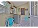 Functional laundry room with modern appliances, storage shelves, chalkboard, and stylish tiled floors at 303 Washington St, New Smyrna Beach, FL 32168