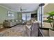 Comfortable living room with a plush sofa, armchair, and plenty of natural light at 303 Washington St, New Smyrna Beach, FL 32168