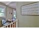 Sitting area with small table, two chairs, and a welcoming sign that reads 'Gathering IS FOREVER' at 303 Washington St, New Smyrna Beach, FL 32168