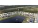 An aerial view of a community surrounding a pond with a fountain, highlighting the neighborhood layout at 3245 Carpentaria Dr, New Smyrna Beach, FL 32168