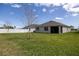 The backyard is an expansive lawn with a privacy fence, perfect for outdoor activities and relaxation at 3245 Carpentaria Dr, New Smyrna Beach, FL 32168