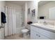 Bright bathroom with a shower-tub combo and white vanity, complete with neutral walls and stone-like flooring at 3245 Carpentaria Dr, New Smyrna Beach, FL 32168