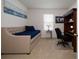 This bedroom comes complete with a small daybed and a built-in desk making for the perfect flexible space at 3245 Carpentaria Dr, New Smyrna Beach, FL 32168
