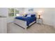 Comfortable bedroom with a large window, carpet flooring, and a beach painting on the wall at 3245 Carpentaria Dr, New Smyrna Beach, FL 32168