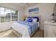 Cozy bedroom featuring a large window with a street view at 3245 Carpentaria Dr, New Smyrna Beach, FL 32168