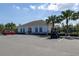 A community clubhouse surrounded by palm trees with a playground and ample parking for visitors at 3245 Carpentaria Dr, New Smyrna Beach, FL 32168