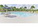 Community pool with chairs, palm trees, table with umbrella and well maintained clear, blue water at 3245 Carpentaria Dr, New Smyrna Beach, FL 32168