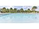 Large clear blue community pool with lounge chairs and palm trees around the pool at 3245 Carpentaria Dr, New Smyrna Beach, FL 32168