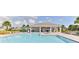 A beautiful community pool surrounded by lounge chairs, palm trees, and a shaded cabana area at 3245 Carpentaria Dr, New Smyrna Beach, FL 32168