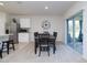 Bright dining area features a wooden table set, sliding glass doors, and neutral-toned carpet at 3245 Carpentaria Dr, New Smyrna Beach, FL 32168