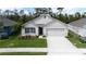 Charming one story home with a well-manicured lawn, landscaped garden beds, and a two-car garage for ample parking at 3245 Carpentaria Dr, New Smyrna Beach, FL 32168