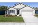 Charming single-story home featuring a manicured lawn, attached garage and a welcoming entrance at 3245 Carpentaria Dr, New Smyrna Beach, FL 32168