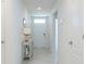 Hallway with a decorative table and a white front door at 3245 Carpentaria Dr, New Smyrna Beach, FL 32168