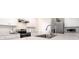 Modern kitchen with stainless steel appliances, white cabinets, and a stylish range hood at 3245 Carpentaria Dr, New Smyrna Beach, FL 32168