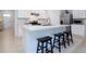 Bright kitchen with a large island, stylish stools, and modern appliances for a functional cooking space at 3245 Carpentaria Dr, New Smyrna Beach, FL 32168