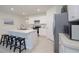 Modern kitchen featuring a center island with seating, stainless steel appliances, and white cabinets at 3245 Carpentaria Dr, New Smyrna Beach, FL 32168