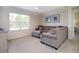 Comfortable living room is well-lit with neutral decor and a large window at 3245 Carpentaria Dr, New Smyrna Beach, FL 32168