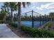 The pickleball courts have blue surface and a black chain link fence with tropical trees around the courts at 3245 Carpentaria Dr, New Smyrna Beach, FL 32168