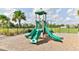Community playground area with slide, climbing structure and protective wood chip ground cover at 3245 Carpentaria Dr, New Smyrna Beach, FL 32168